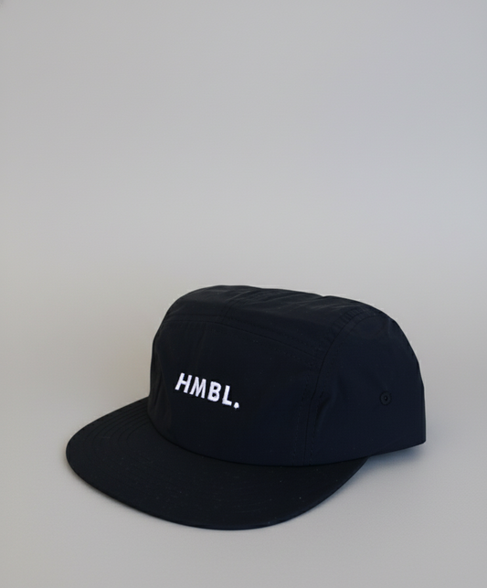 Black cap with 'HMBL.' logo on a white background
